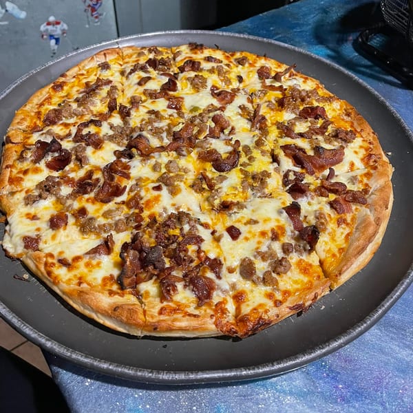Tony's Pizzeria & Sports Bar's meat lover's pizza, topped with bacon and sausage.