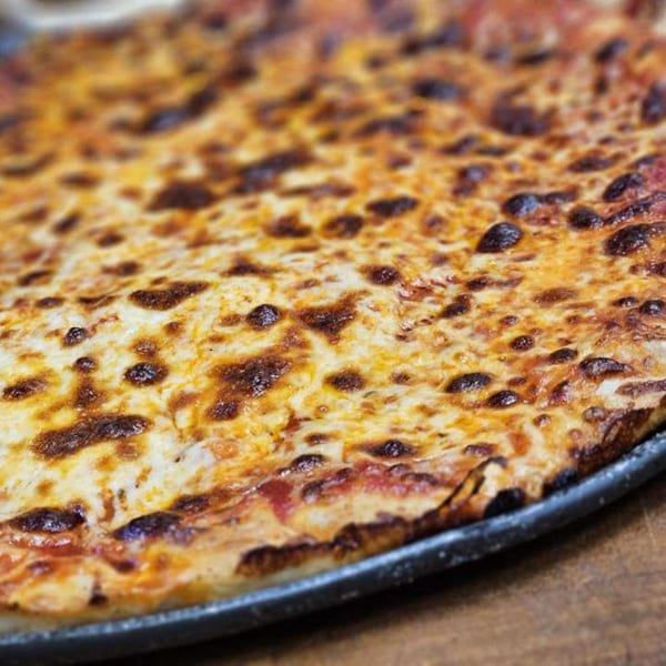 Close-up of a Tony's Pizzeria & Sports Bar cheese pizza with bubbly, browned cheese.